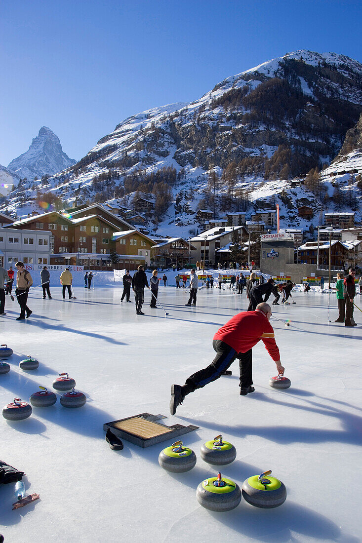 People curling on a rink, Matterhorn in background, Zermatt, Valais, Switzerland
