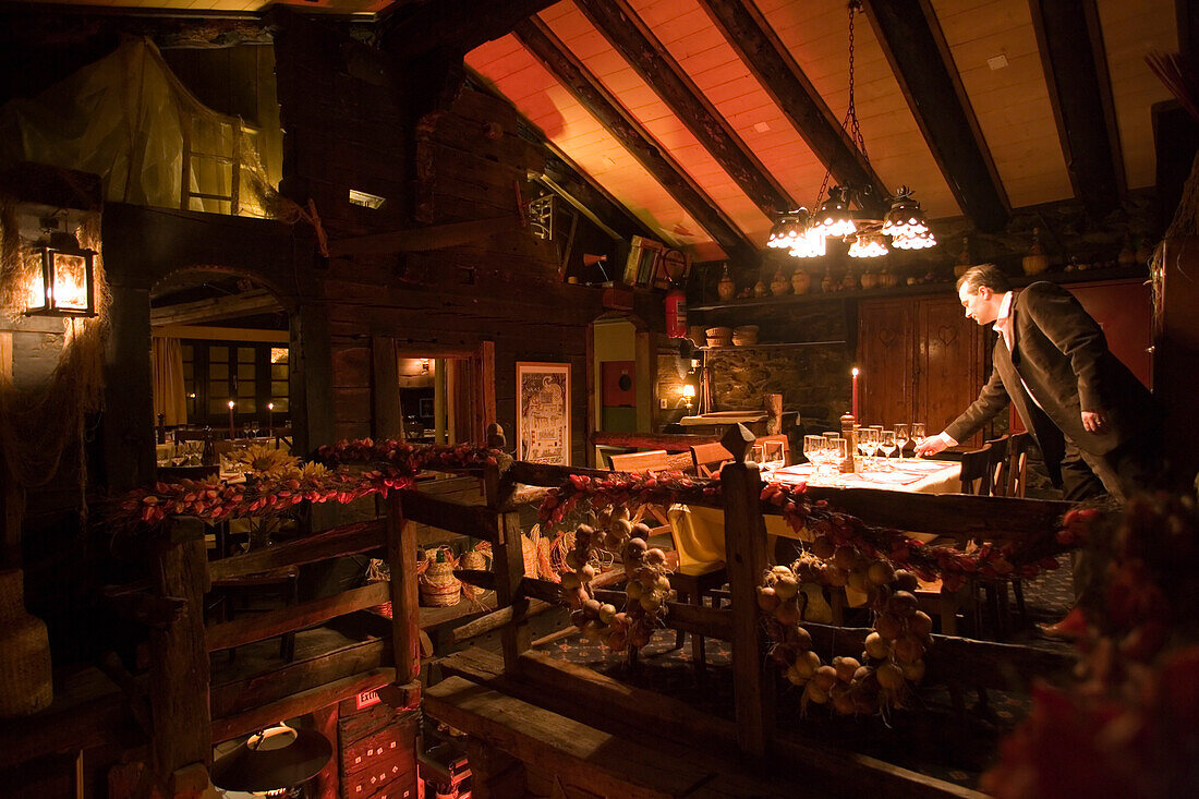 Waiter setting the table in the Restaurant Portofino, the first class restaurant of Hotel Post, Zermatt, Valais, Switzerland