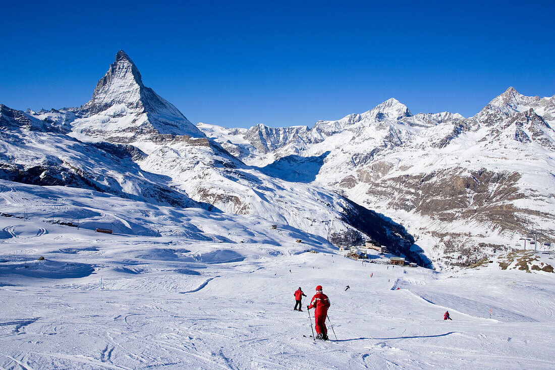 Skiers on mountain slope, Matterhorn (4478 m) in background, Zermatt, Valais, Switzerland