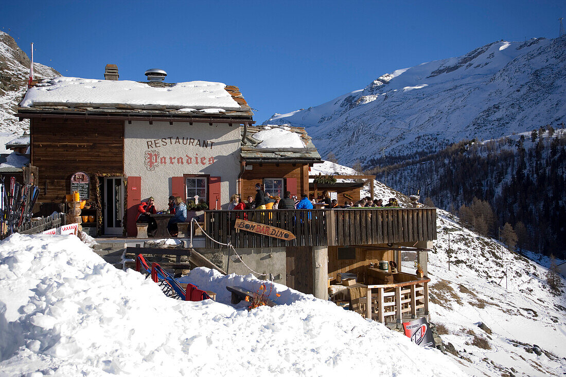 People sitting on terrace of Restaurant Paradies (2540 m), Findeln, Zermatt, Valais, Switzerland