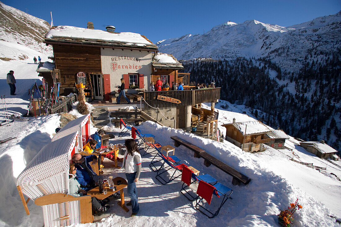 People sitting on terrace of Restaurant Paradies (2540 m), Findeln, Zermatt, Valais, Switzerland