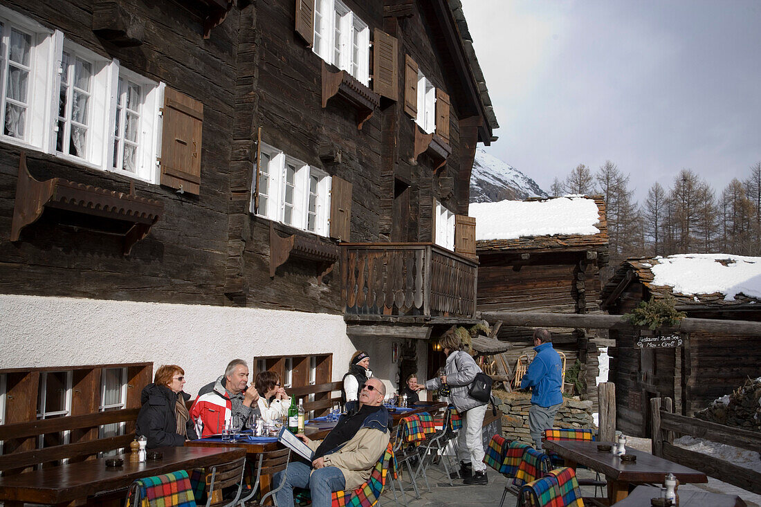 People resting on terrace of Restaurant Zum See, Zum See, Zermatt, Valais, Switzerland