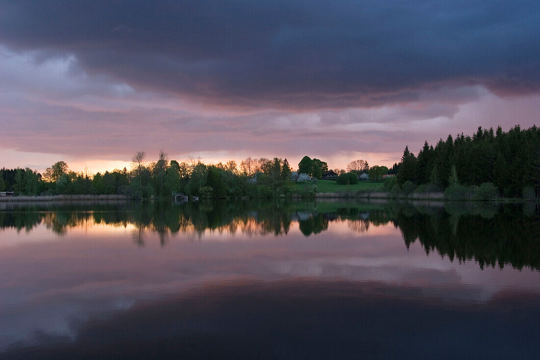 Thunderstorm emerging over Lake Huber See, Penzberg, Upper Bavaria, Germany