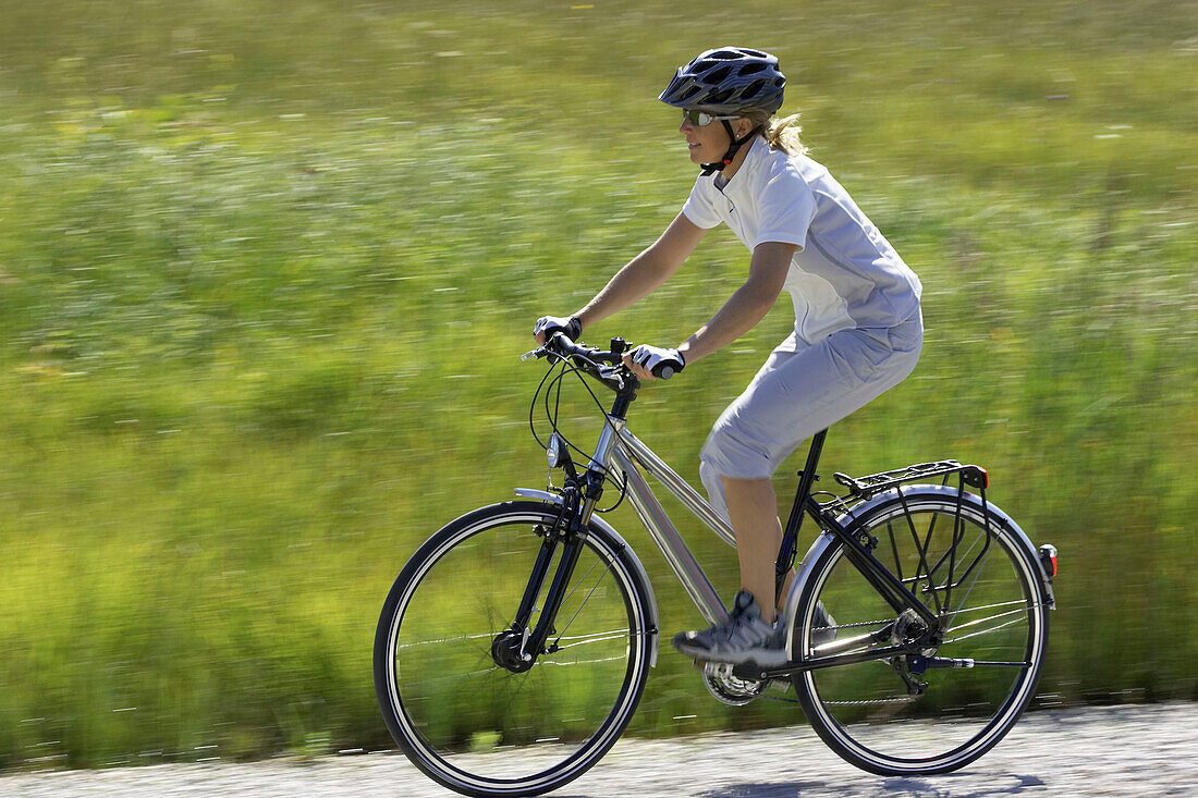 Young woman riding bicycle, Germany