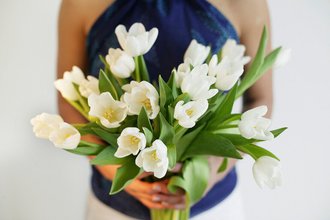 Young woman holding a bunch of tulips, Vienna, Austria