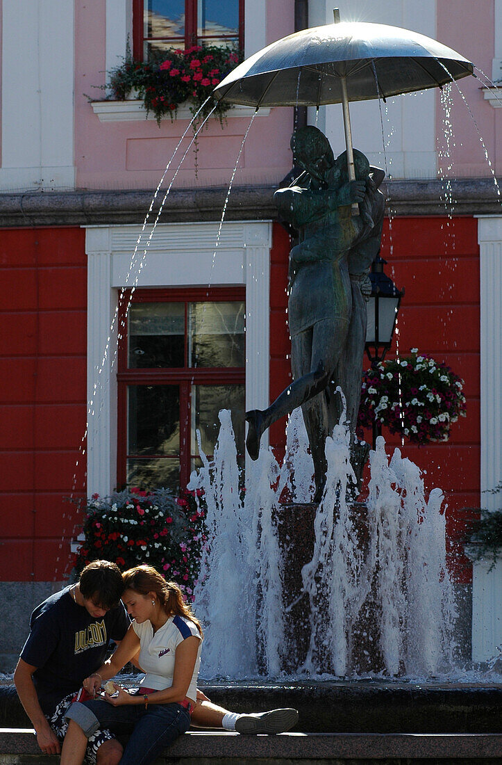 couple at fountain in front of town hall, Tartu, Estonia