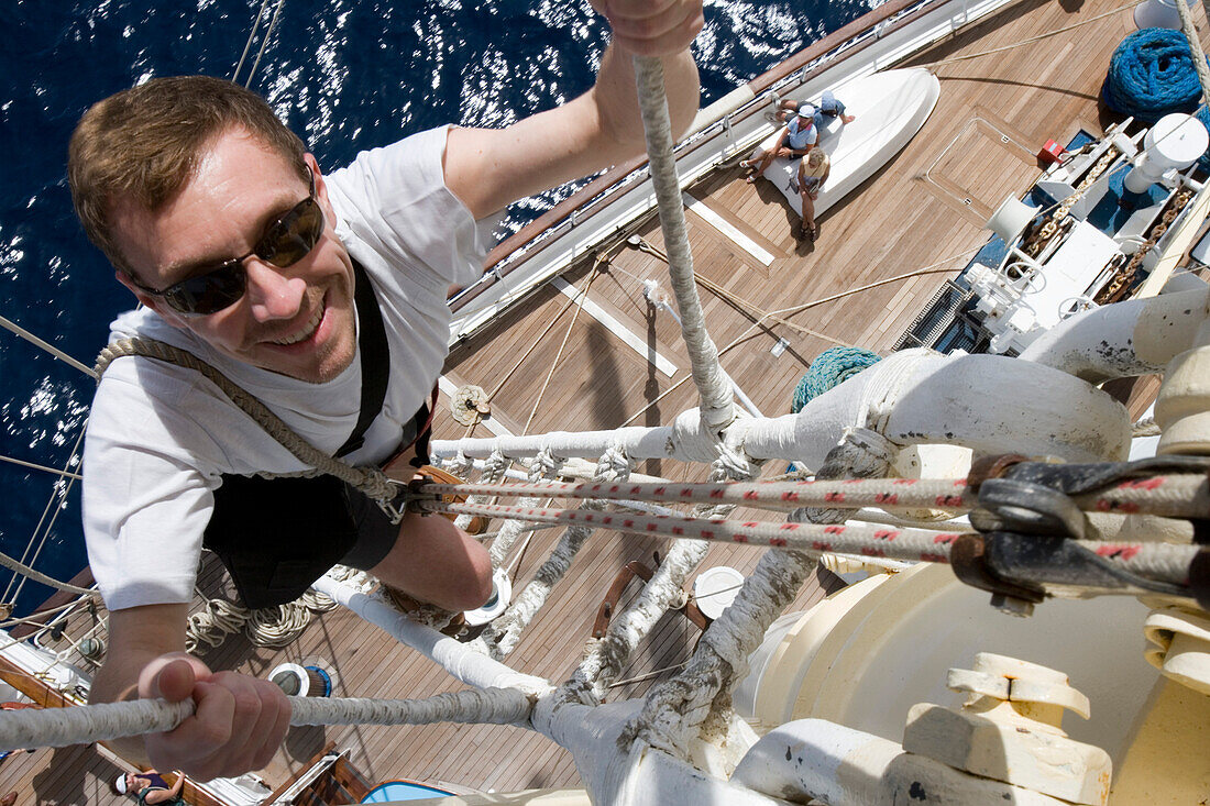 Man climbing a mast on the Star Clipper, Caribbean Sea