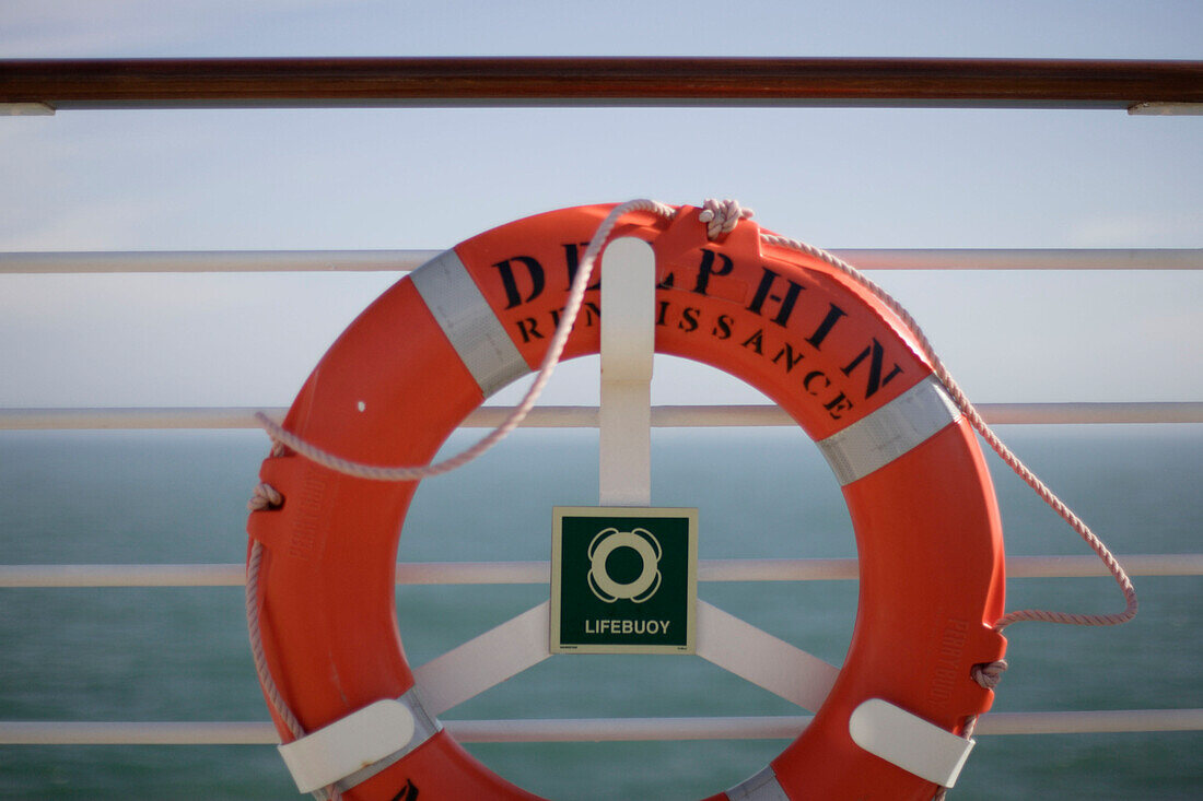 A life belt hanging at the railing, cruise ship MS Delphin Renaissance