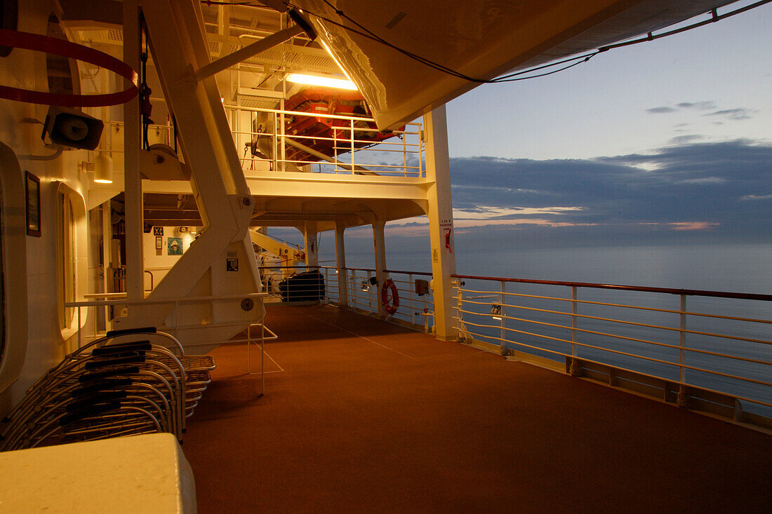 Beleuchtetes, menschenleeres Deck bei Sonnenuntergang, Kreuzfahrtschiff MS Delphin Renaissance