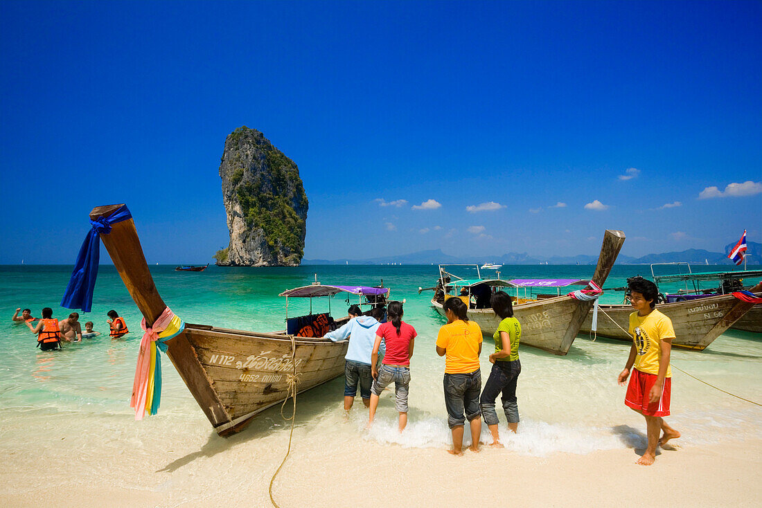 Boats anchored at beach, Tourists with lifejackets standing in water, Ko Poda in background, Laem Phra Nang, Railay, Krabi, Thailand