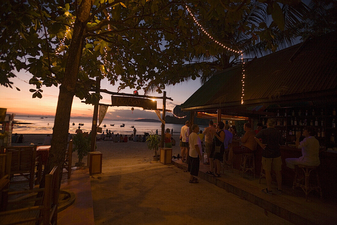 Tourists visiting BoBo's Plaza, a beach bar, at beach Hat Rai Leh, Railay West in the late evening, Laem Phra Nang, Railay, Krabi, Thailand, after the tsunami
