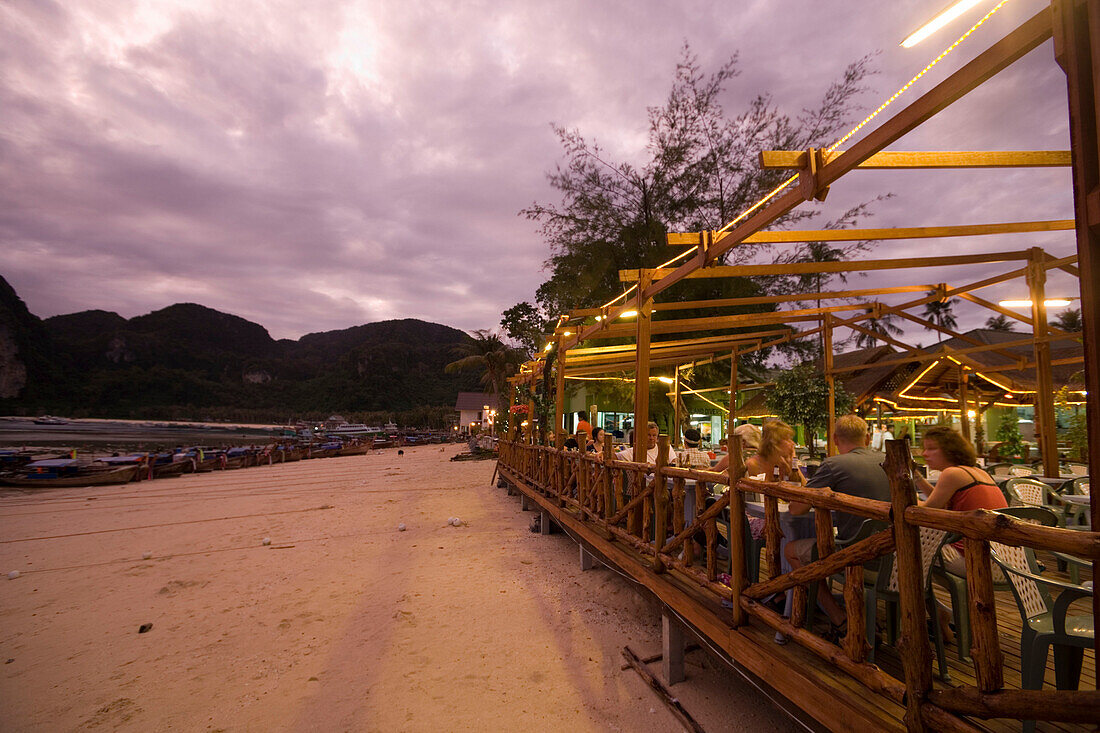 People sitting on a beach terrace of a restaurant in the evening, Ko Phi Phi Don, Ko Phi Phi Island, Krabi, Thailand, after the tsunami