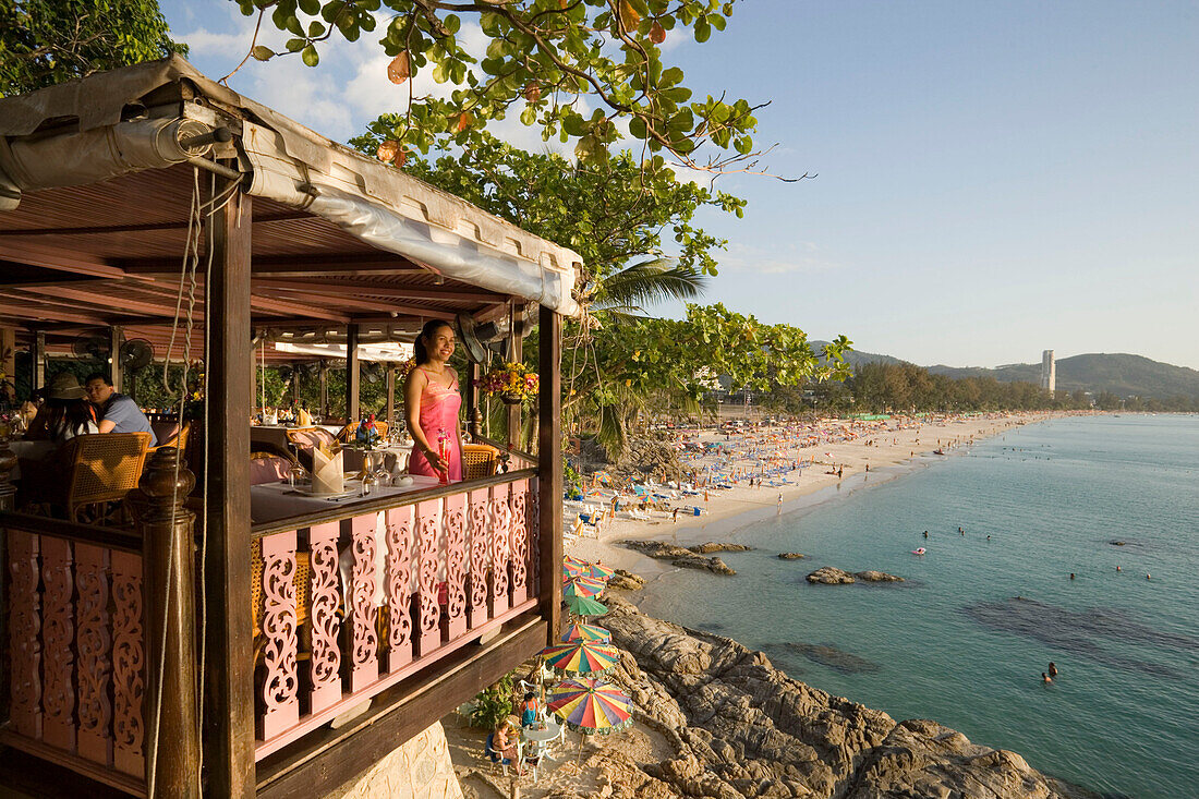 Young woman standing on terrace of Baan Rim Pa restaurant and enjoying the stunning ocean view, Patong Beach, Hat Patong, Ao Patong, Phuket, Thailand, after the tsunami