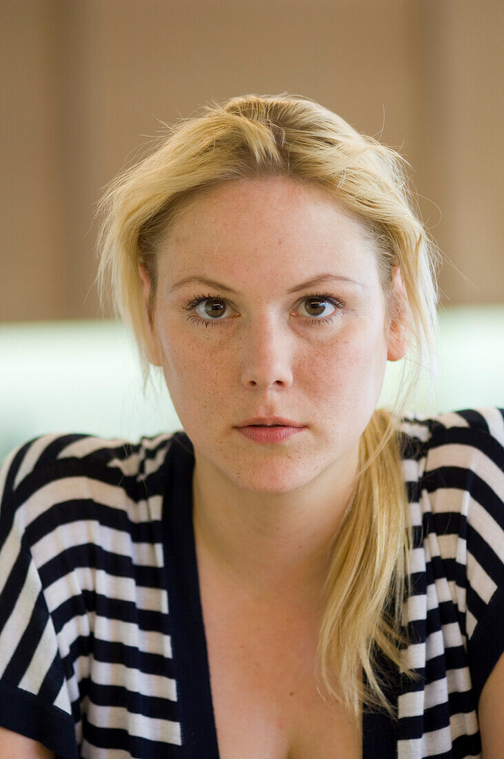 Portrait of a young, blond woman wearing striped top
