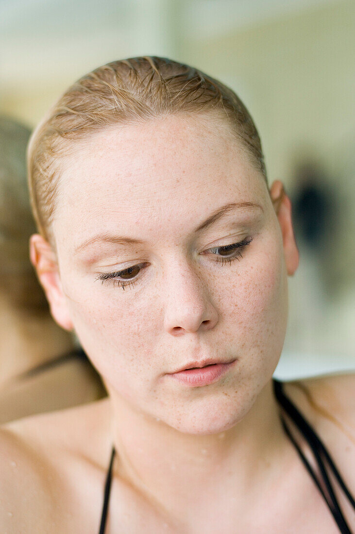 Woman after swimming at poolside, Germany