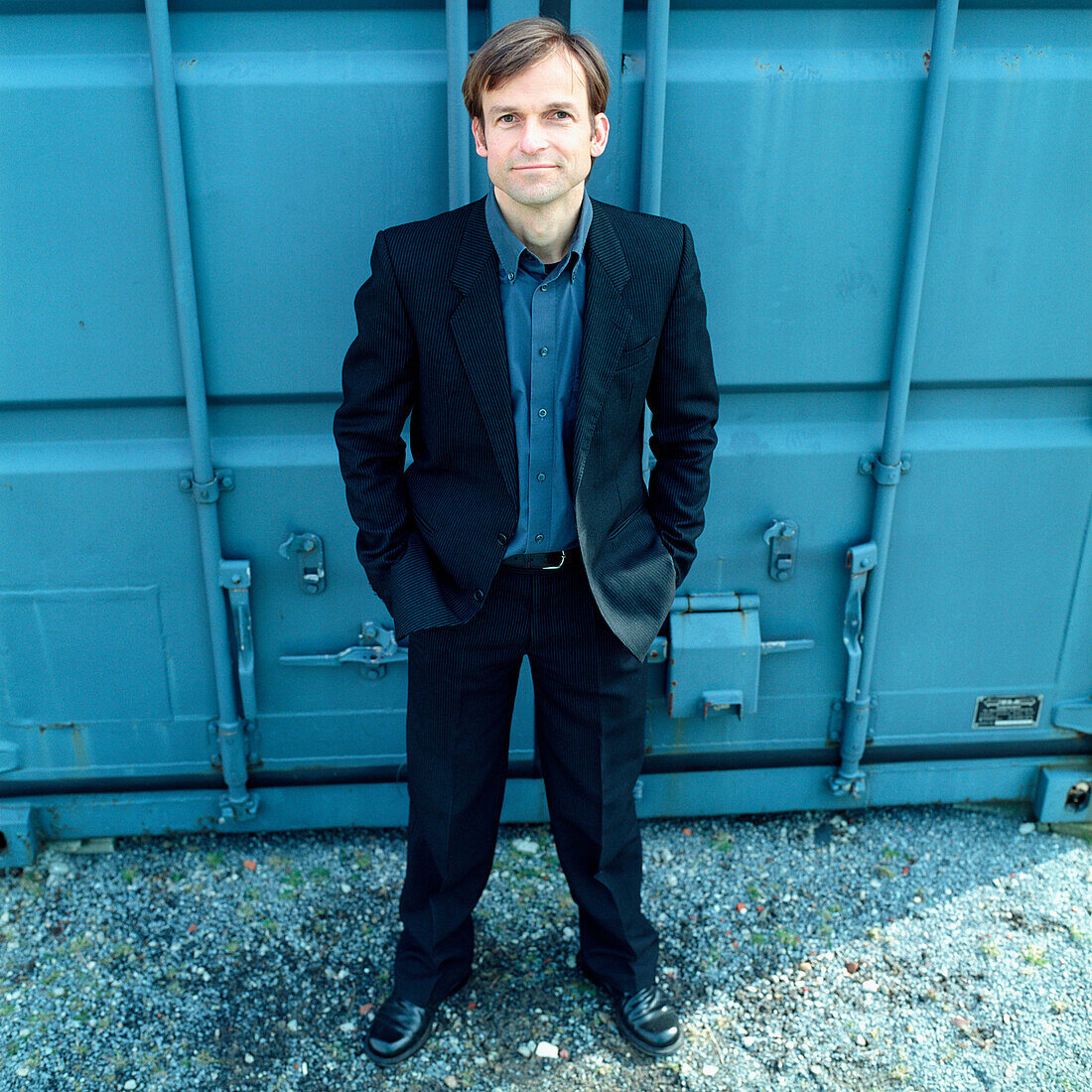 Buisnessman standing in front of a container