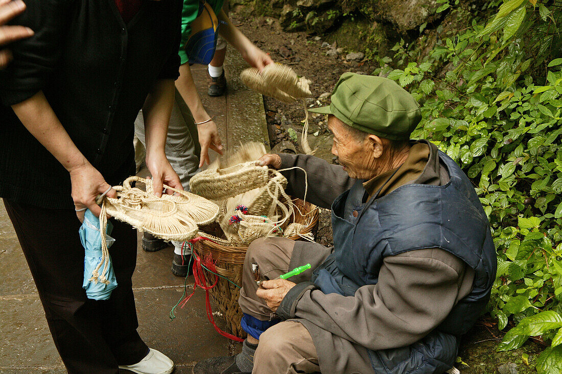 path and stairs, sales people, selling handmade straw sandals, traditional pilgrim sandals, mountains, Emei Shan, China, Asia, World Heritage Site, UNESCO