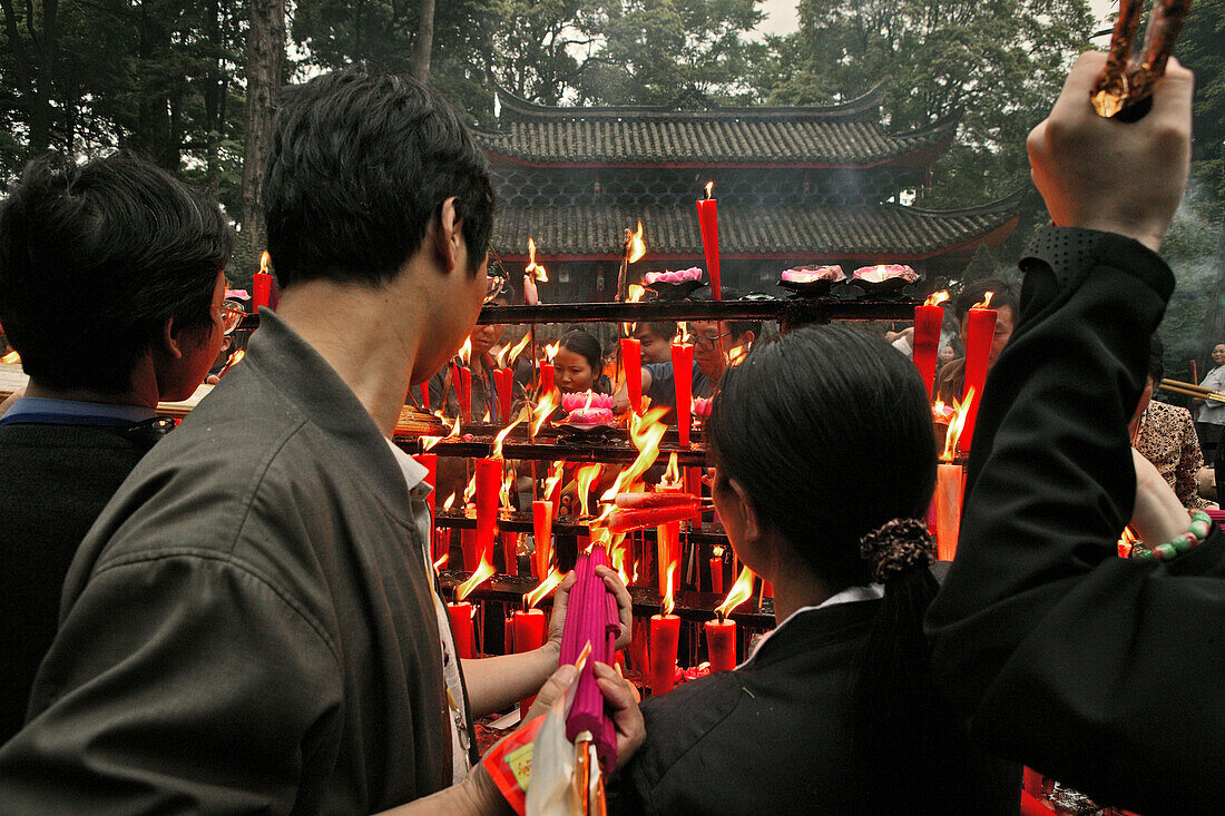 Pilgrims burning incense sticks and candles in front of the temple, Wannian monastery, Emei Shan, Sichuan province, China, Asia
