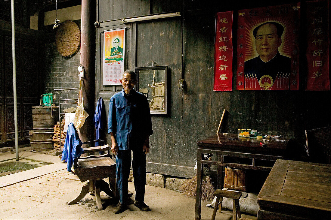 village barber, Mao portrait, courtyard of timber house in Chengkun, ancient village, living museum, China, Asia, World Heritage Site, UNESCO