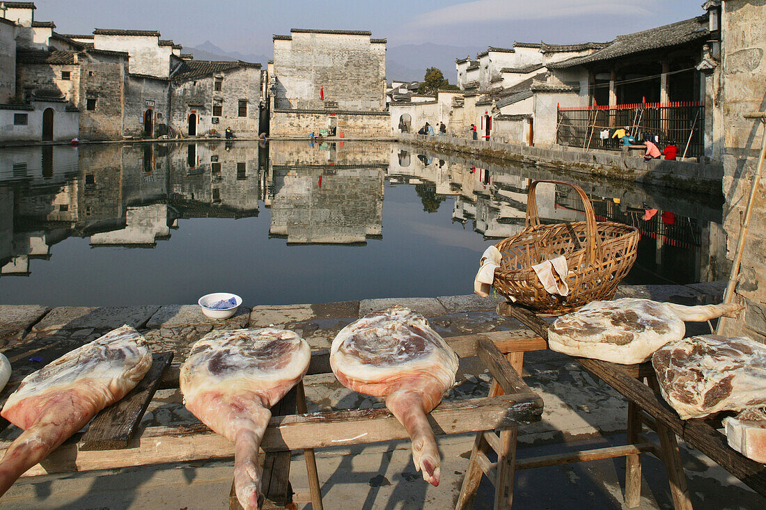 Sales stand with ham in front of pond at the village Hongcun, Huangshan, China, Asia