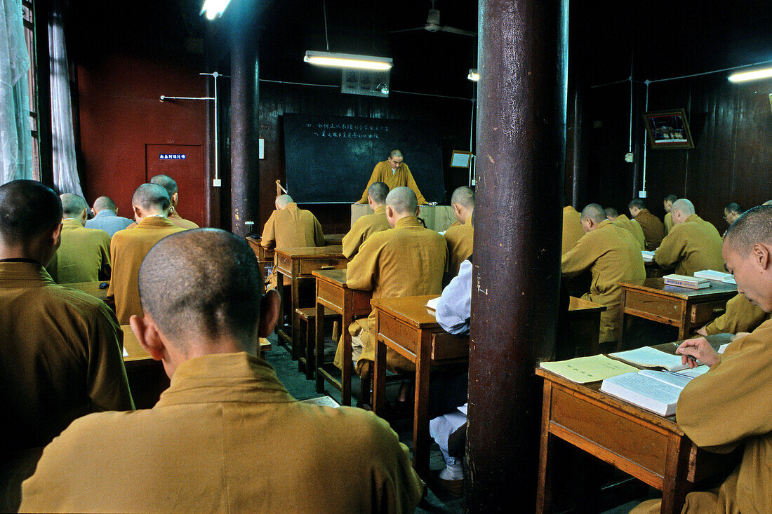 Monks at the lecture hall of the Buddhist College, Jiuhua Shan, Anhui province, China, Asia