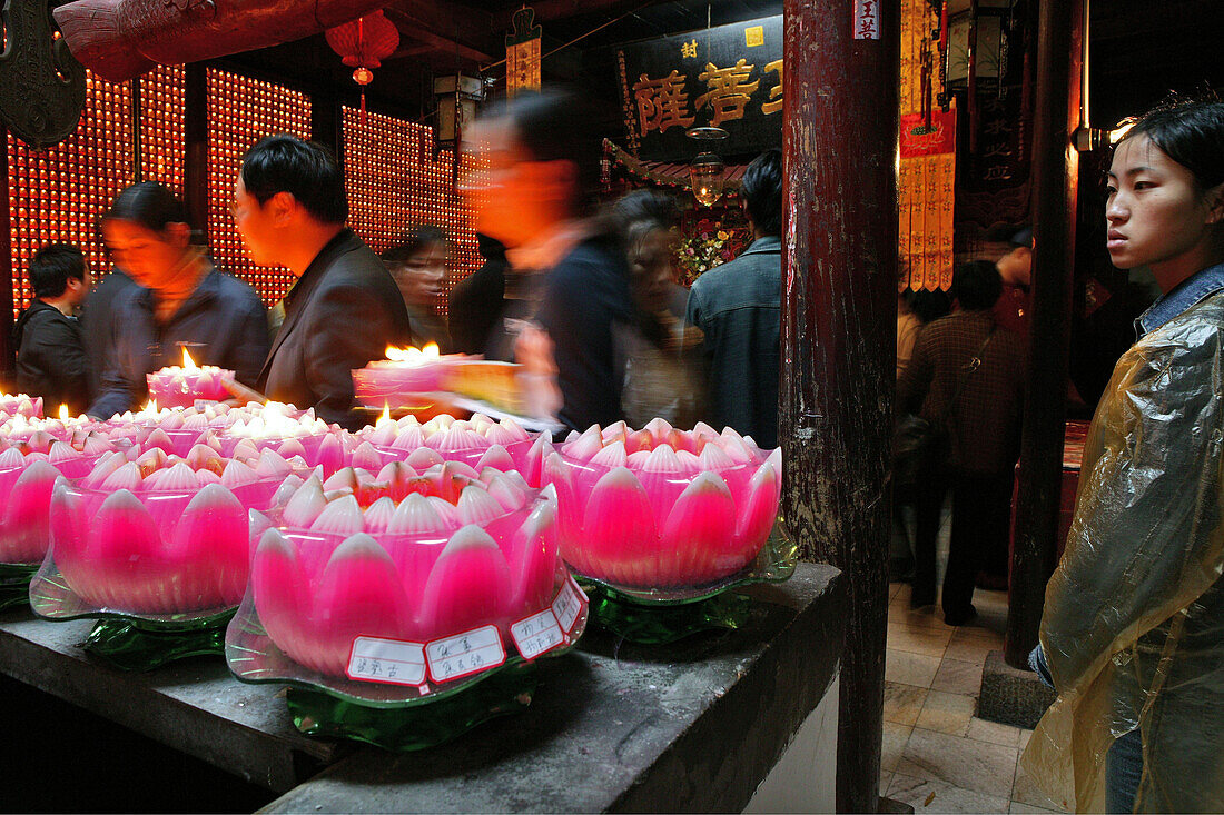 Pilgrims lighting up candles in the form of lotus flowers, Longevity monastery, Jiuhua Shan, Anhui province, China, Asia