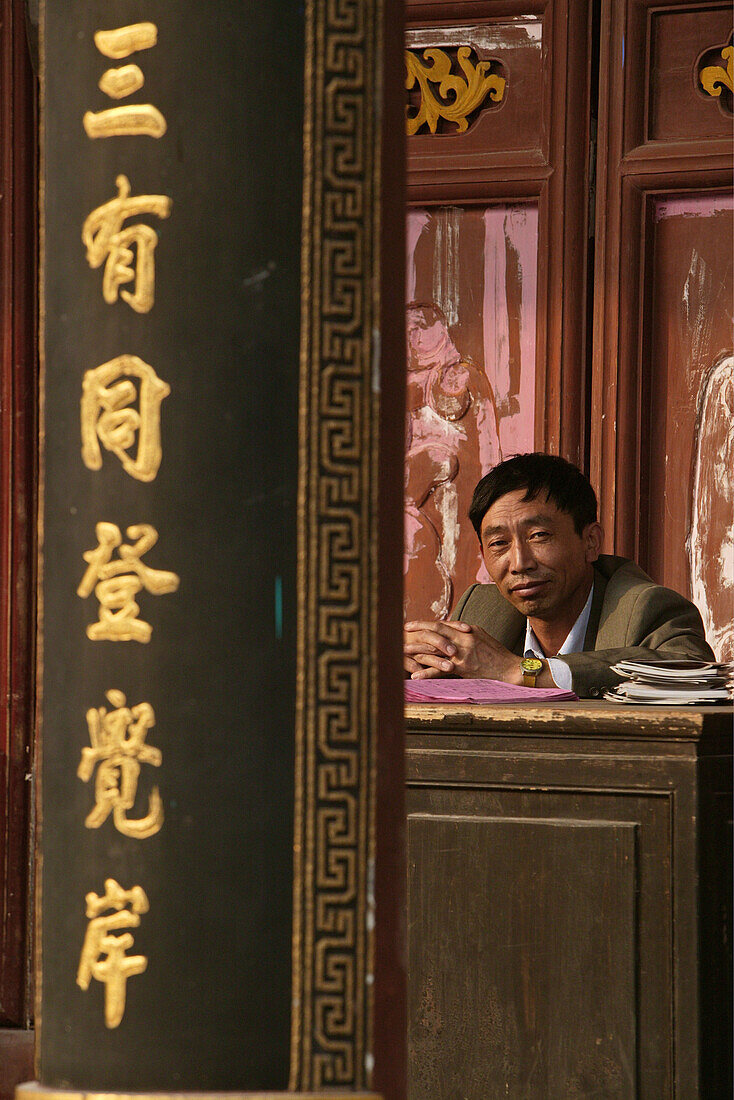 clerk in office, Huiji monastery, Buddhist Island of Putuo Shan near Shanghai, Zhejiang Province, East China Sea, China, Asia