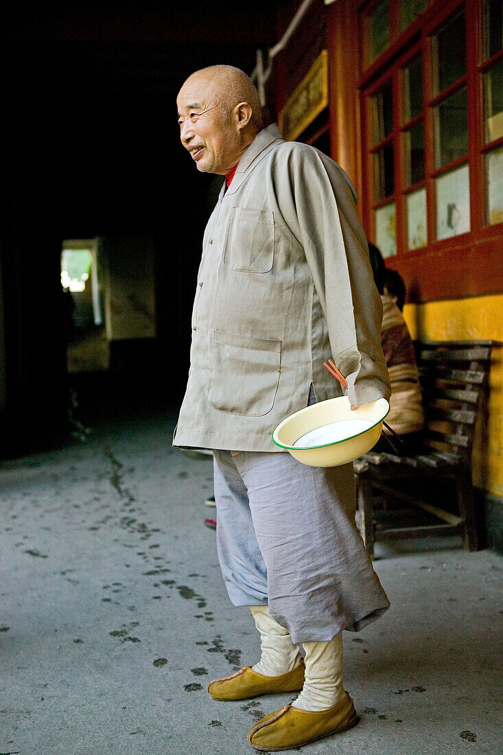 Smiling monk holding rice bowl, Putuo Shan, Zhejiang Province, China, Asia