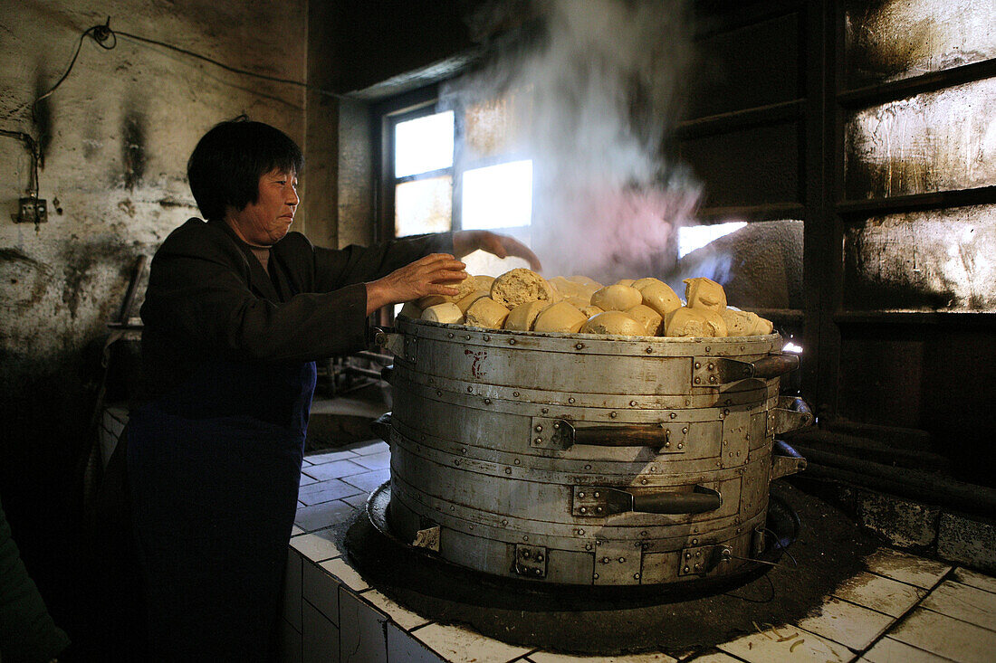 Woman making steamed buns inside the kitchen of Fawang Monastery, Shaolin monastery, known for Shaolin boxing, Taoist Buddhist mountain, Song Shan, Henan province, China