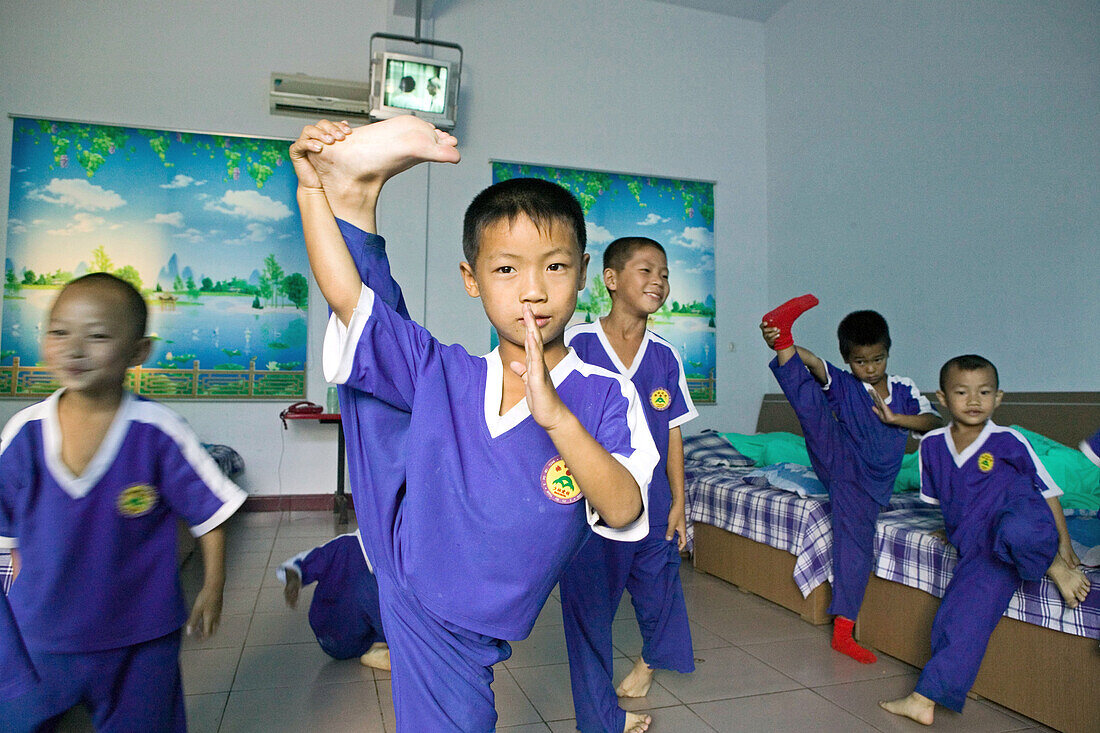 Very young pupils in the dormitory, Kung Fu training at kindergarten age at one of the many new Kung Fu schools in Dengfeng, Song Shan, Henan province, China
