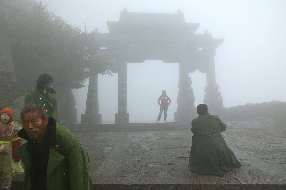 Pilgrims, tourists in rain capes, at the entrance to Bixia Si temple, Southern Gate to Heaven, Mount Tai, Tai Shan, Shandong province, World Heritage, UNESCO, China