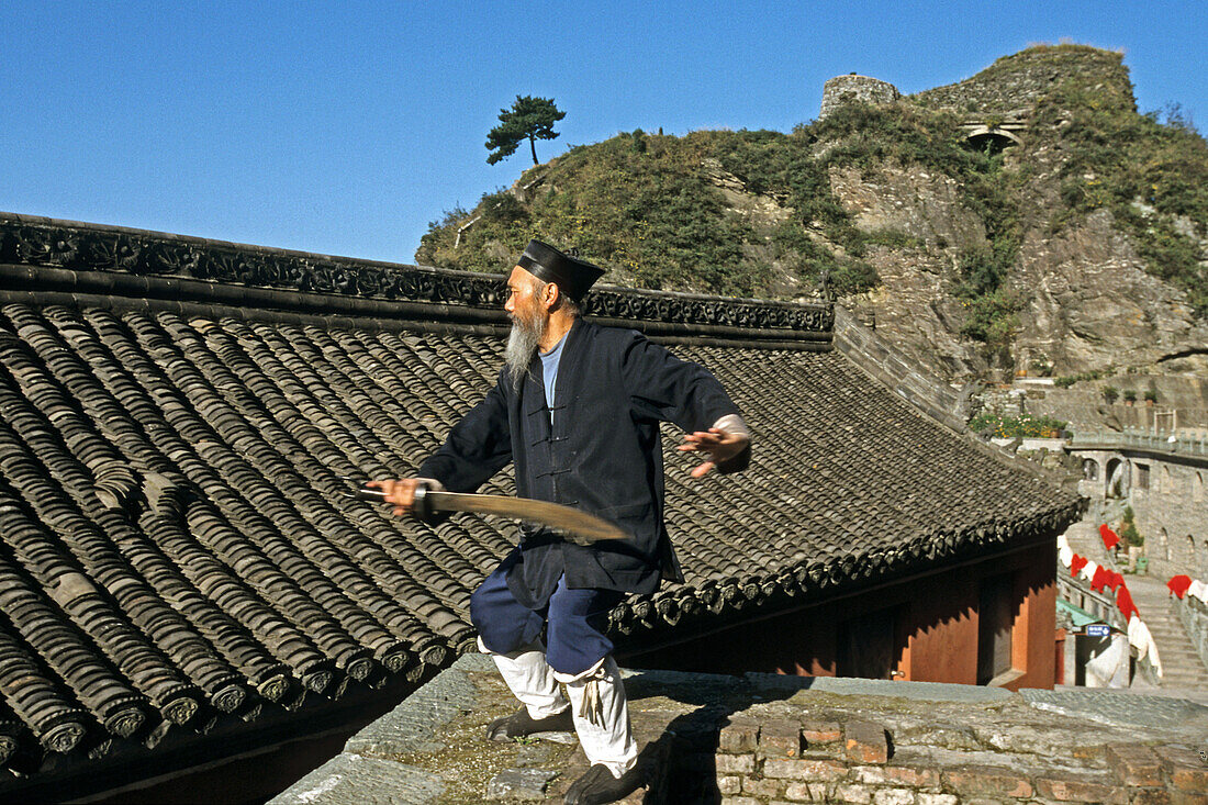 Taichi master and monk demonstrating a ritual sword fight, Tianzhu feng temple, Mount Wudang, Wudang Shan, Taoist mountain, Hubei province, UNESCO world cultural heritage site, birthplace of Tai chi, China