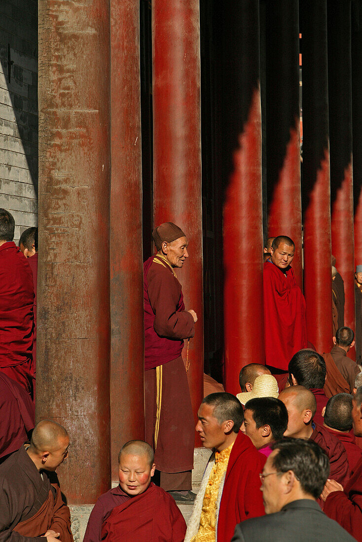 Buddhist monks attending a prayer ceremony to honour Wenshus, red columns of the temple, Xiantong Monastery, Wutai Shan, Five Terrace Mountain, Buddhist Centre, town of Taihuai, Shanxi province, China