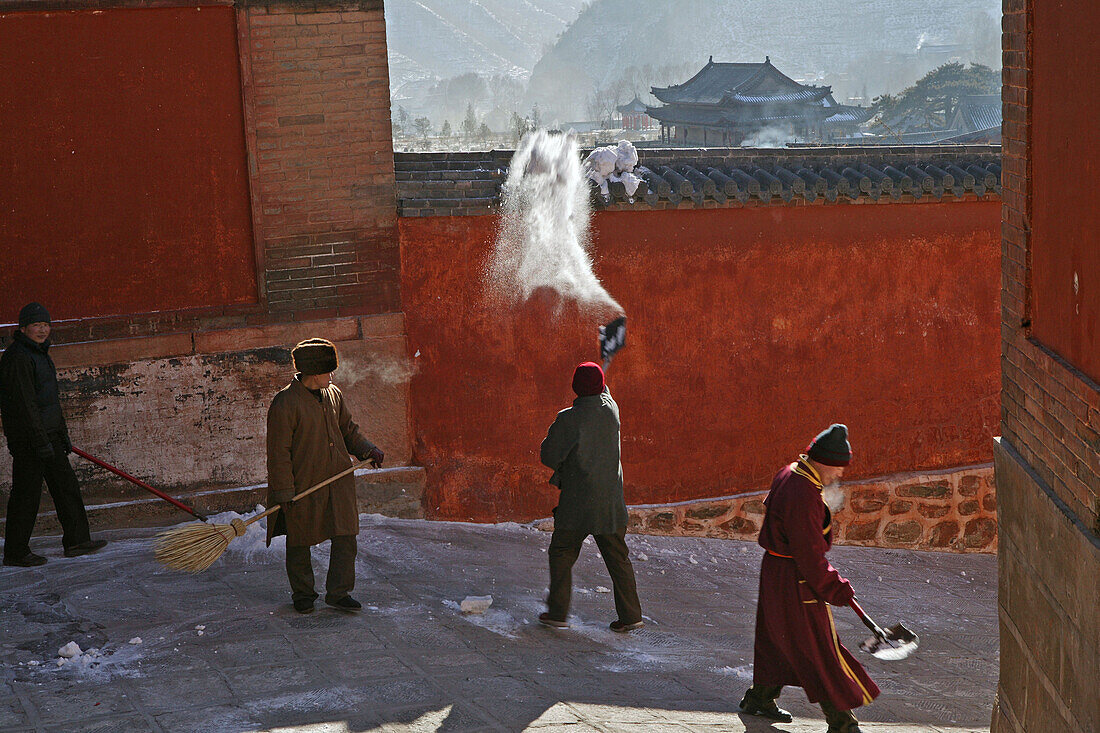 Monks clearing snow, high walls of monastery, Xiantong Monastery, Wutai Shan, Five Terrace Mountain, Buddhist Centre, town of Taihuai, Shanxi province, China