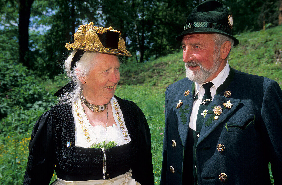 elderly couple in dirndl dress and traditional dress, pilgrimage to Raiten, Schleching, Chiemgau, Upper Bavaria, Bavaria, Germany