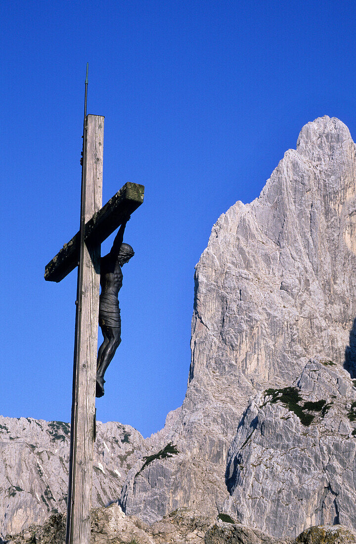 Cross in front of the north pillar of Predigtstuhl, Kaiser Mountain Range, Tyrol, Austria