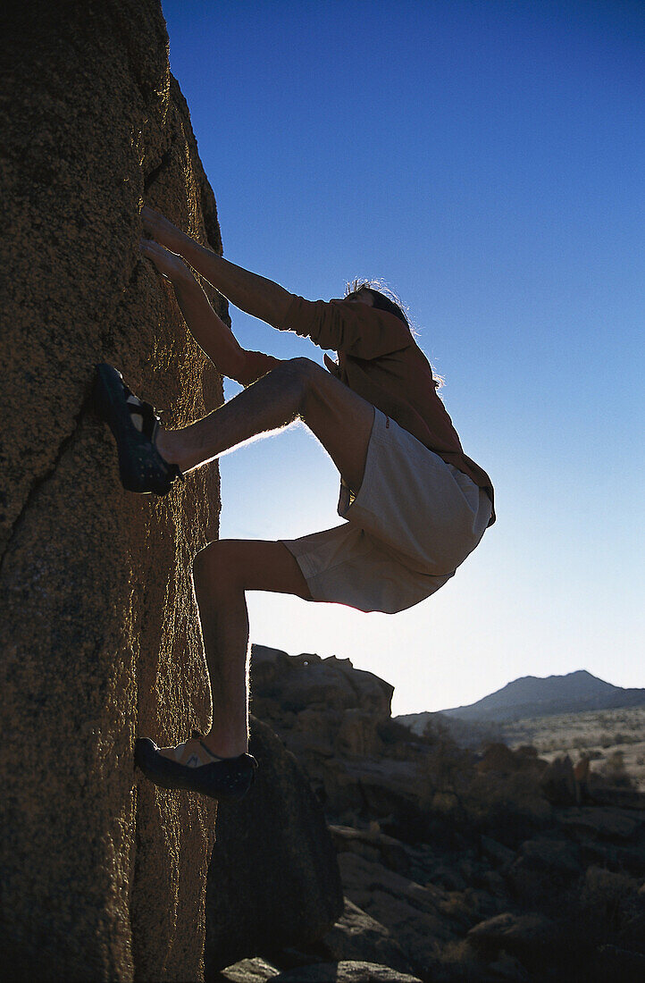 Man bouldering, Tafraout, Morocco, Africa