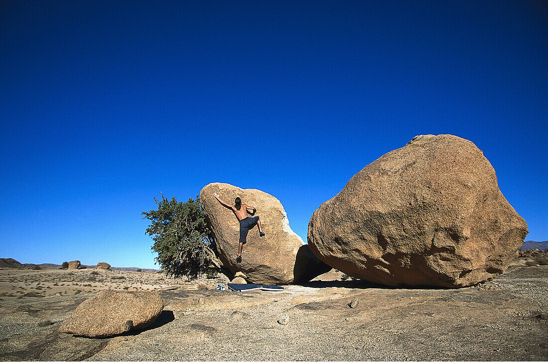 Man bouldering, Tafraoute, Morocco