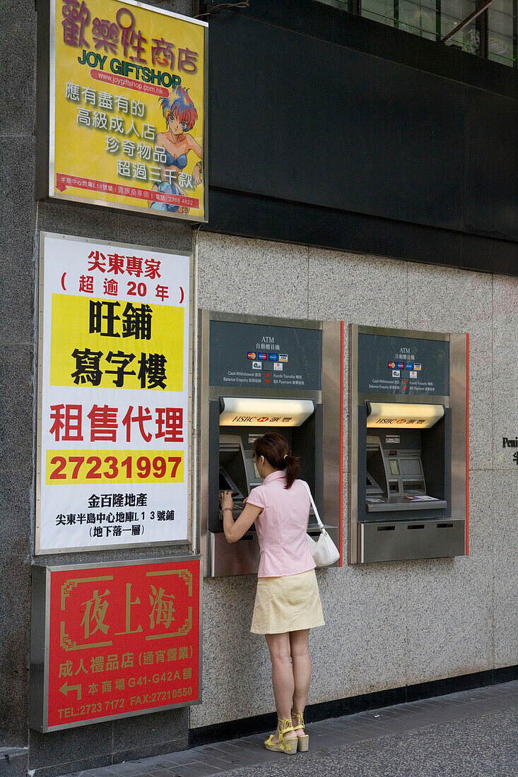 Woman at HSBC Bank ATM Machine, Mong Kok, Kowloon, Hong Kong