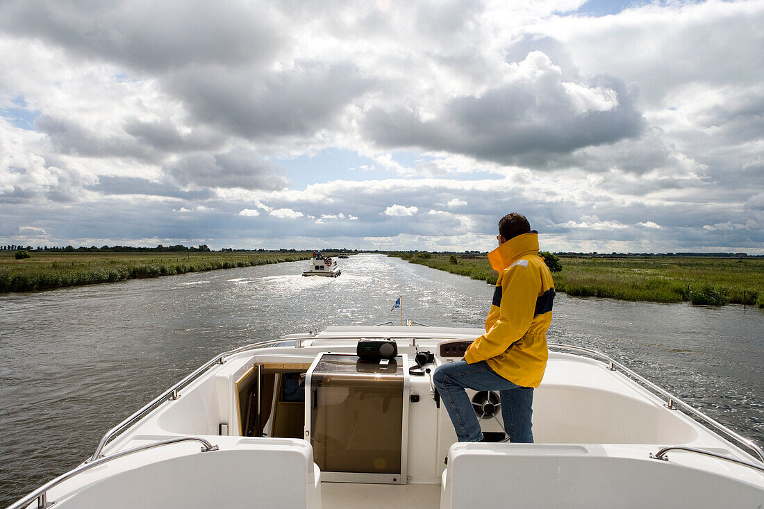 Houseboat Skipper Navigating Janesloot River,Crown Blue Line Royal Classic, Frisian Lake District, Netherlands