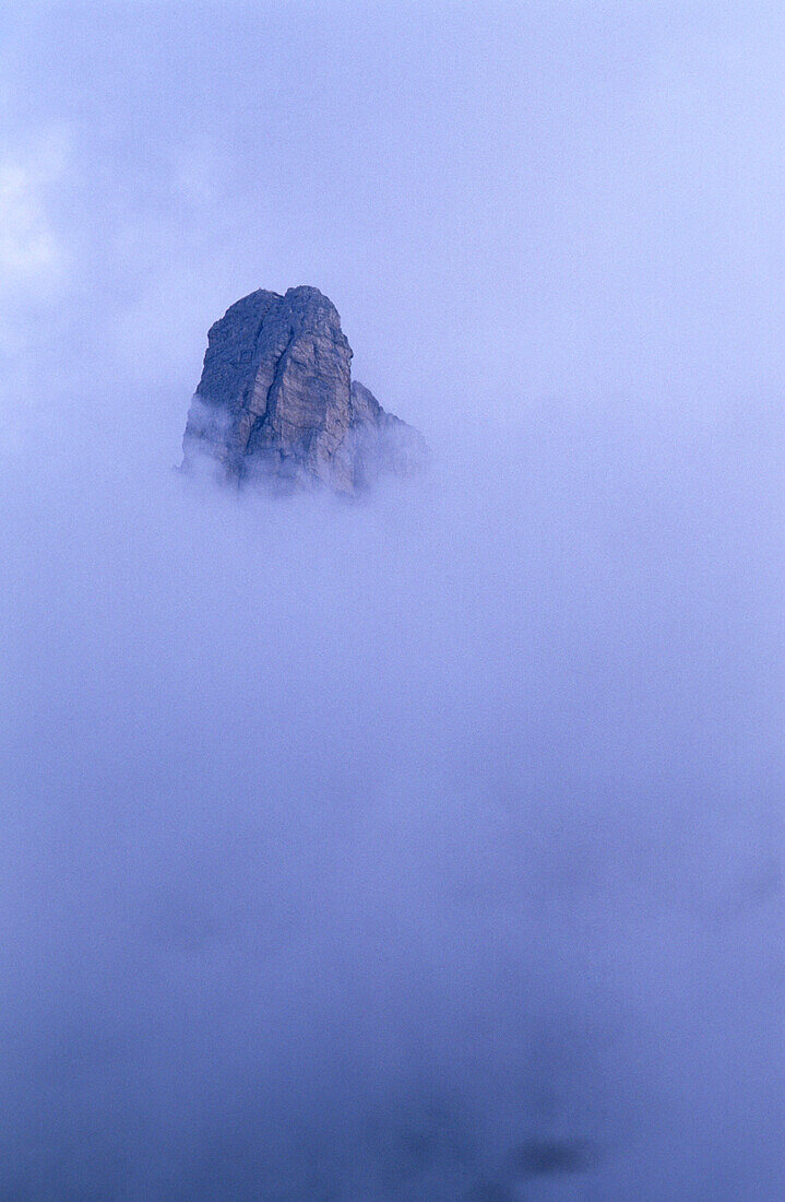 Summit of Gusela in fog from Passo Giau, Ampezzo Dolomites, Dolomites, Veneto, Italy