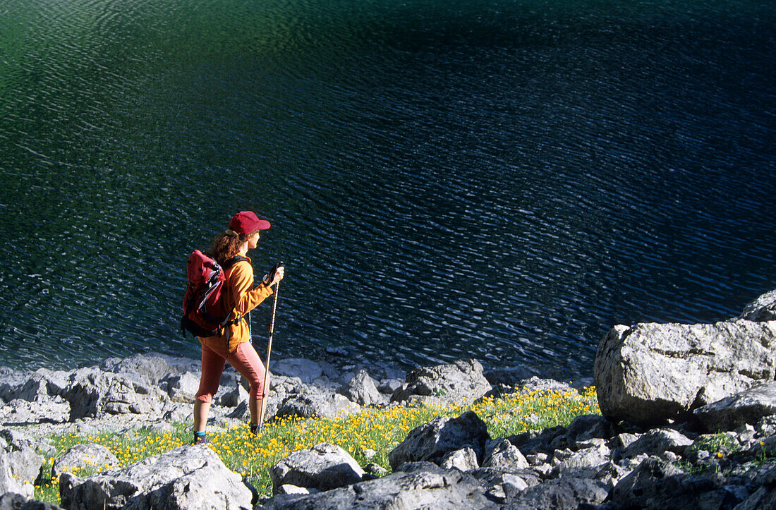 Hiker at the blue green lake, Hinterer Gosausee, Dachstein range, Upper Austria, Austria