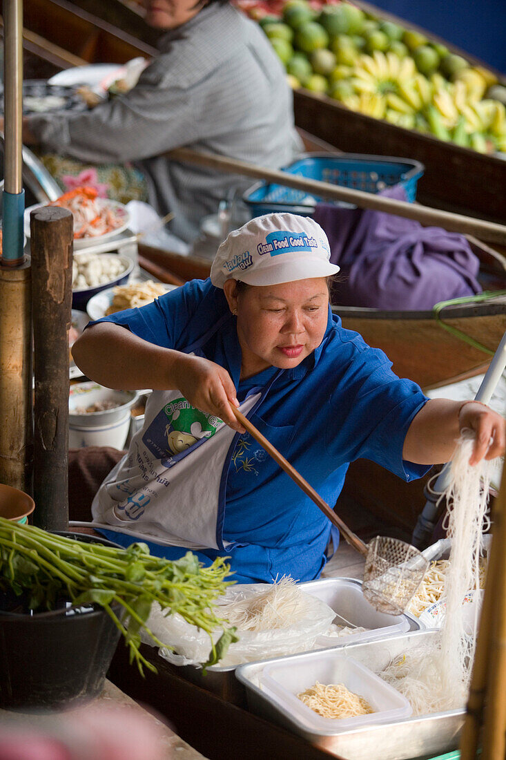Woman cooking in a boat at Floating Market, Damnoen Saduak, near Bangkok, Ratchaburi, Thailand