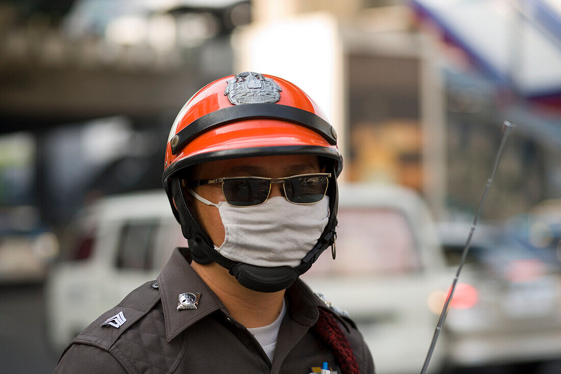 Policeman protecting against air pollution, Sukhumvit Road, Bangkok, Thailand