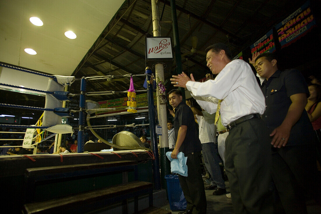 Coach applauding during a Thai boxing competition, Lumphini Stadium, Bangkok, Thailand