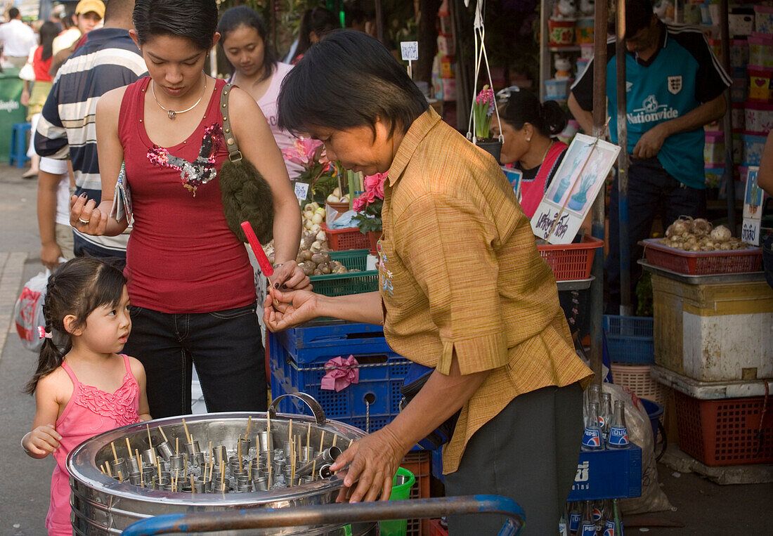 Child buying Sweets at Suan Chatuchak Weekend Market, Bangkok, Thailand