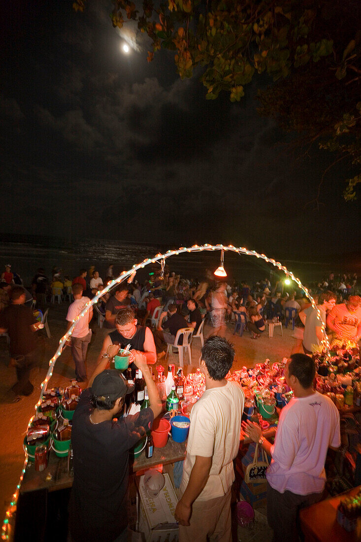 Young people at a Full Moon Party, bar in foreground, Hat Rin Nok, Sunrise Beach, Ko Pha-Ngan, Thailand