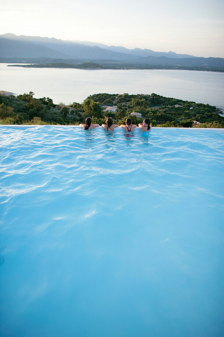 Children resting on pool edge, bay of Porto Vecchio, Southern Corse, France