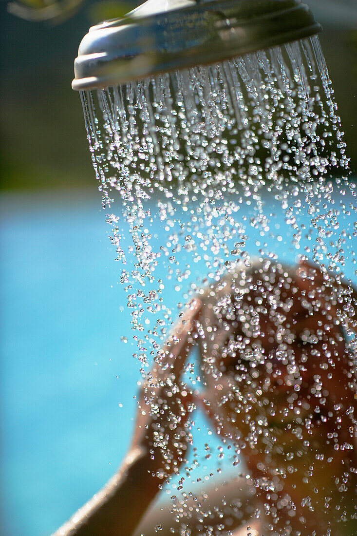 Woman taking a shower, bay of Porto Vecchio, Southern  Corse, France