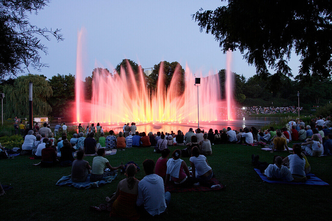 Illuminated fountain, park in the city center, district Neustadt, Hamburg, Germany